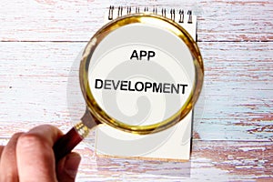 Business, programming, interface, application and network concept. Text APP DEVELOPMENT in a notebook through a