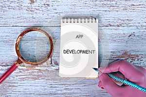 Business, programming, interface, application and network concept. Text APP DEVELOPMENT in the notebook on the old