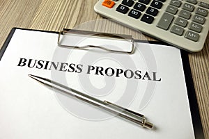 Business proposal document with pen and calculator