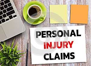 Business quotes, PERSONAL INJURY CLAIMS on notebook or paper in office desk, office workplace
