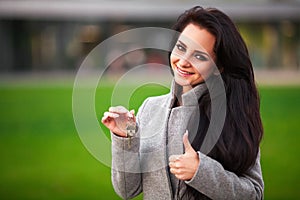 Business, real estate, banking and people concept - smiling business woman with keys over office room or new apartment background