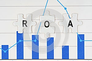 On business reports - diagrams are puzzles with the inscription - ROA