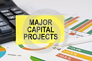 On business reports there is a calculator and a sign with the inscription - Major Capital Projects