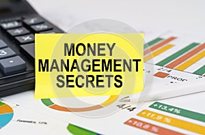 On business reports there is a calculator and a sign with the inscription - Money Management Secrets