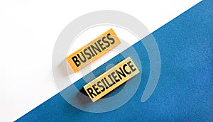 Business resilience symbol. Concept word Business resilience typed on wooden blocks. Beautiful white and blue paper background.