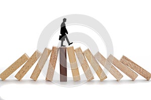 Business risks concept, Businessman walking on wooden blocks.