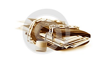 Business safety or financial protection or allow access. Heap of money in chain with open padlock isolated on white