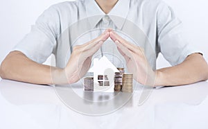 Business salesman hand protection home with money concept home.