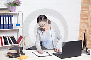 The business Secretary girl works at the computer