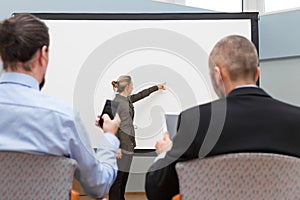 business seminar, woman standing at a empty whiteboard