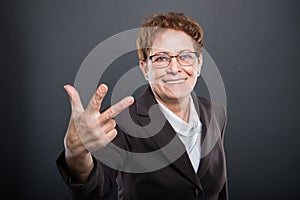 Business senior lady showing number three gesture