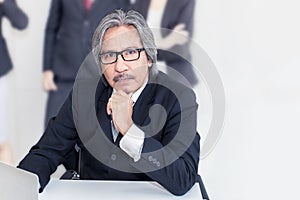 Business senior old man serious in office.He looking smiling .