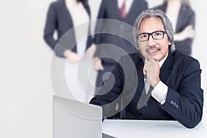 Business senior old man serious in office.He looking smiling .