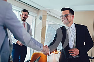 Business shaking hand with a client in office