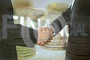 Business shaking hand on finacial graph background.