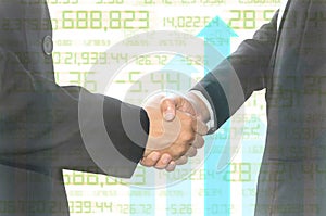 Business shaking hand on finance graph background.