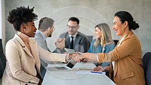 Business shaking hands, finishing up meeting. Successful businesswomen handshaking after good deal.