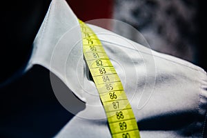 Business shirt tailoring on tailor shop mannequin measure tape