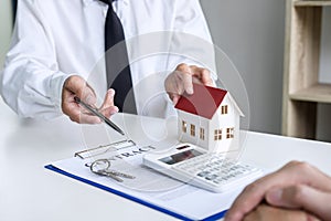 Business Signing a Contract Buy - sell house, insurance agent analyzing about home investment loan Real Estate concept