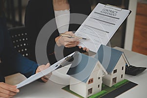 Business Signing a Contract Buy - sell house, insurance agent analyzing about home investment loan Real Estate concept