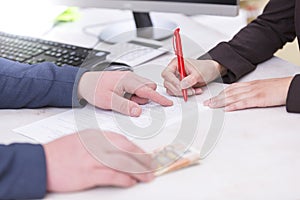 Business situation. Busineswoman signing loan contract,with money, Euro banknotes on