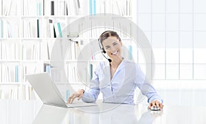 Business smiling woman or a clerk working at her office desk wit