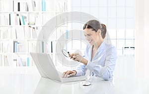 Business smiling woman or a clerk working at her office desk wit