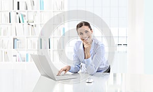Business smiling woman or a clerk working at her office desk wit photo