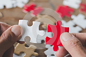 Business solutions, success and strategy concept. Businessman hand connecting jigsaw puzzle