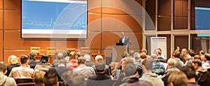 Business speaker giving a talk at business conference event.