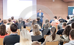 Business speaker giving a talk at business conference event.