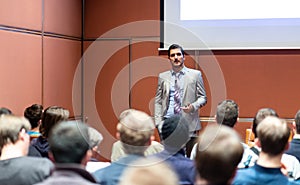 Business speaker giving a talk at business conference meeting event.