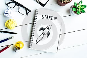 Business startup with notepad on office desk table with supplies