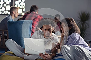 Business, startup, technology and people concept - happy international creative team with laptop and tablet pc computer