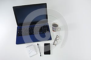 Business still life - laptop, phone, coffee and notebook, on white background