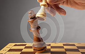 Business strategy concept. Knight making final last step to make checkmate in chess, falling king