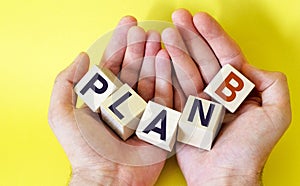 Business strategy and marketing concept, wooden cubes with plan b in the hands of a man