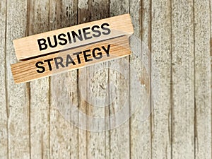 Business strategy text on wooden blocks background. Stock photo.