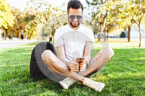 Business and stylish hipster in a white shirt, sitting on the la