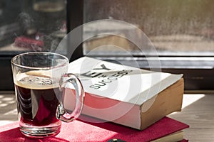 Business of success book and black coffee on wood near window