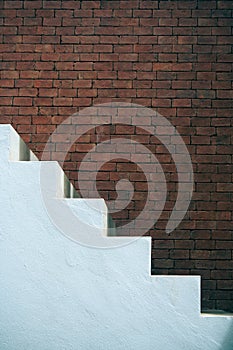 Business Success Concept : Side view of white empty stairs with brown brick wall background.