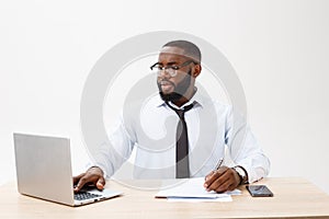 Business and success. Handsome successful African American man wearing formal suit, using laptop computer for distant