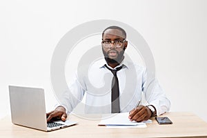 Business and success. Handsome successful African American man wearing formal suit, using laptop computer for distant