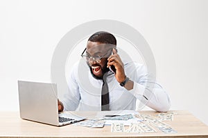 Business and success. Handsome successful African American man wearing formal suit, using laptop computer for distant