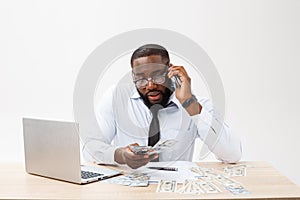 Business and success. Handsome successful African American man wearing formal suit, using laptop computer for distant