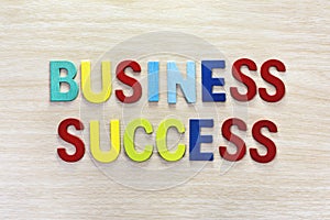 Business success in multicolor on wooden table photo