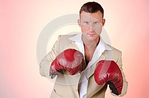 Business and success. Office fight. Young man in boxing gloves. Work and the battle