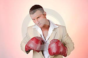 Business and success. Office fight. Young man in boxing gloves. Work and the battle