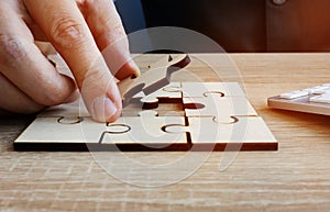 Business success and problem solving. Man holds piece of puzzle photo