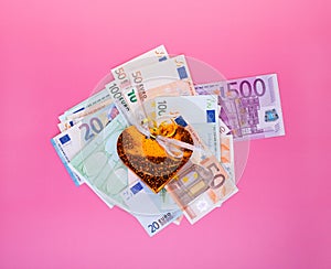 Business success, salary bonuses, profit, investment win and financial increase concept with gift box over euro bills pile on pink